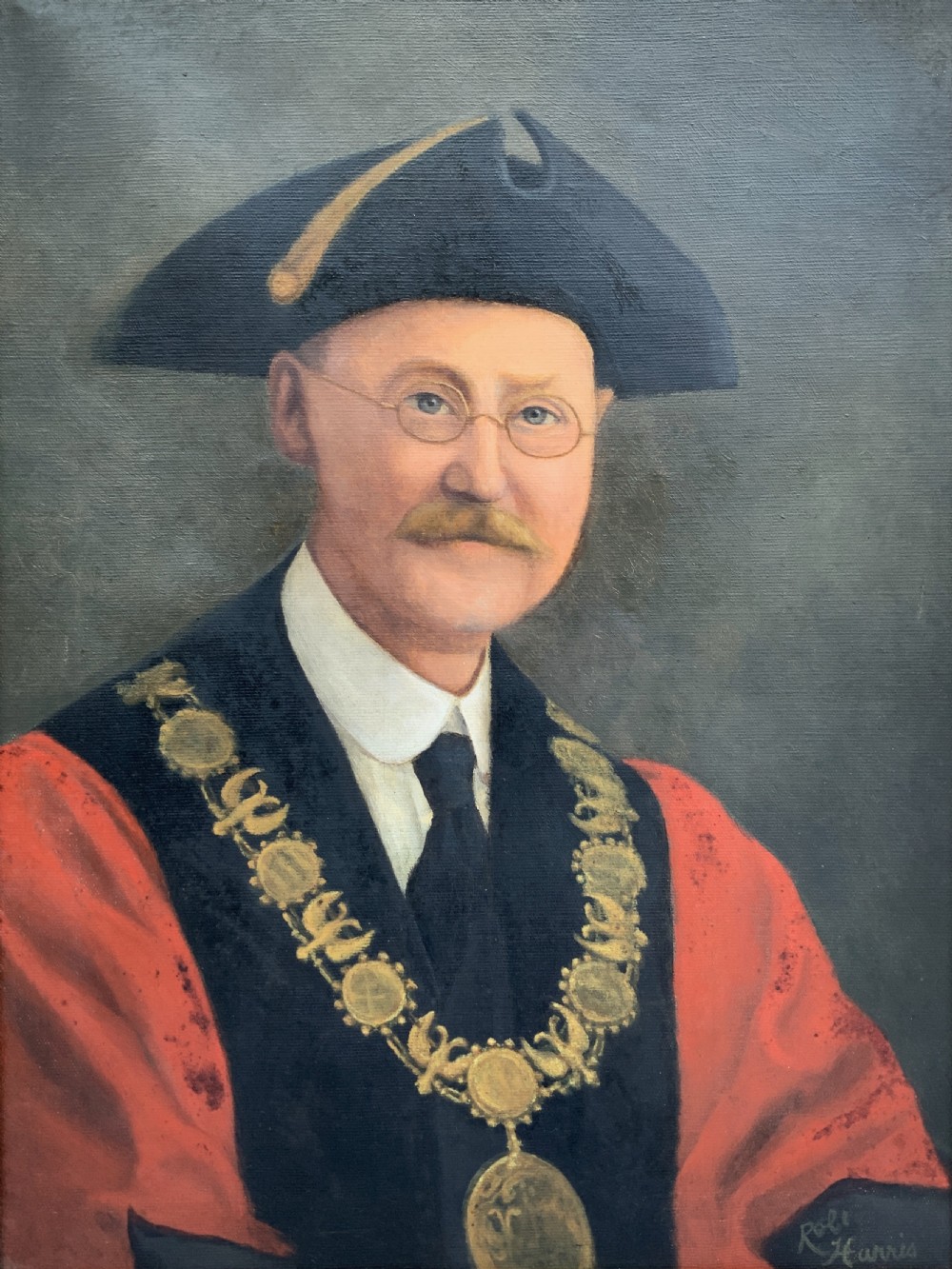An oil portrait of a bespectacled man with a moustache wearing a tricorne hat, dark tie, red ceremonial robes, and a gold mayors chain of office, presented in a gilded wood frame. View III