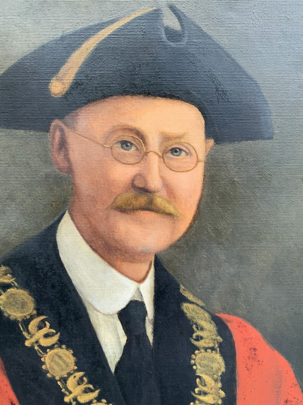 An oil portrait of a bespectacled man with a moustache wearing a tricorne hat, dark tie, red ceremonial robes, and a gold mayors chain of office, presented in a gilded wood frame. View IX