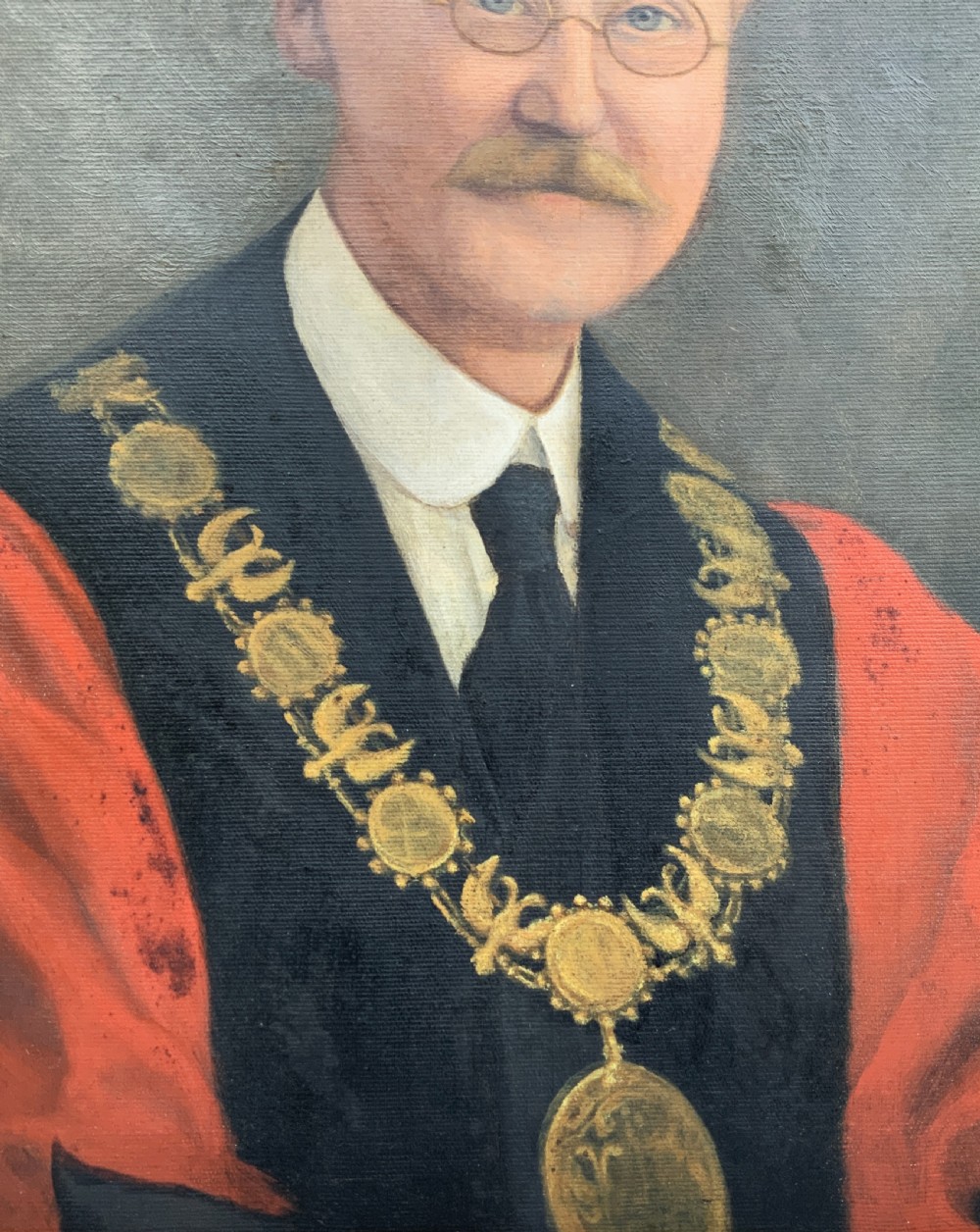 An oil portrait of a bespectacled man with a moustache wearing a tricorne hat, dark tie, red ceremonial robes, and a gold mayors chain of office, presented in a gilded wood frame. View X