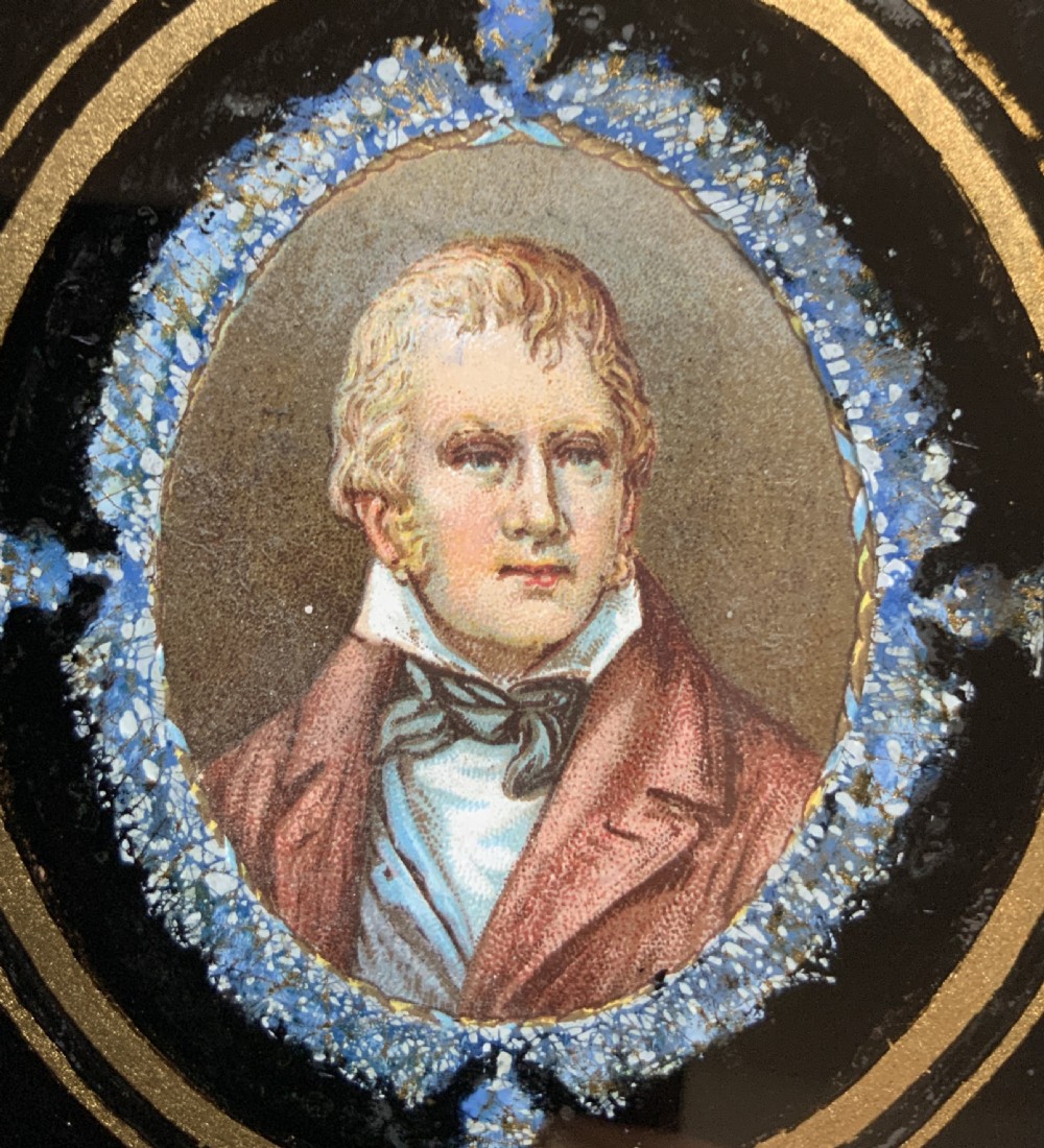 An oval portrait miniature painting of a gentleman set inside a black ebonised Hogarth frame with gilded inner detail. View V