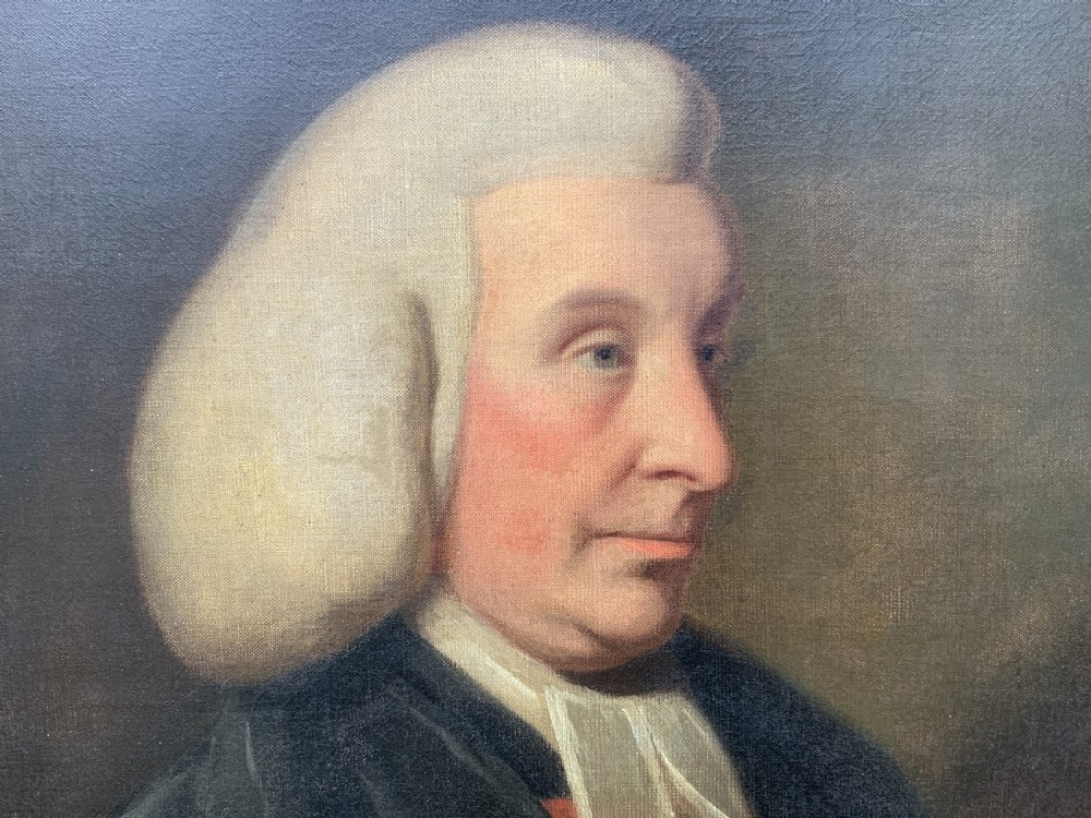 An 18th-century oil portrait of a clergyman in a powdered wig and clerical bands, framed in a carved giltwood frame. View IX