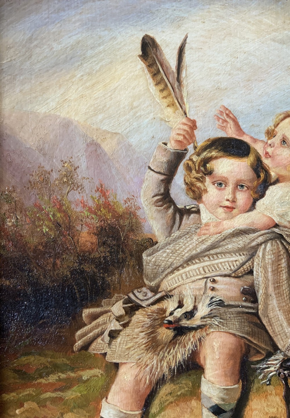 A 19th-century framed oil painting depicting two young children in traditional Scottish Highland dress set within a molded timber frame. View IV
