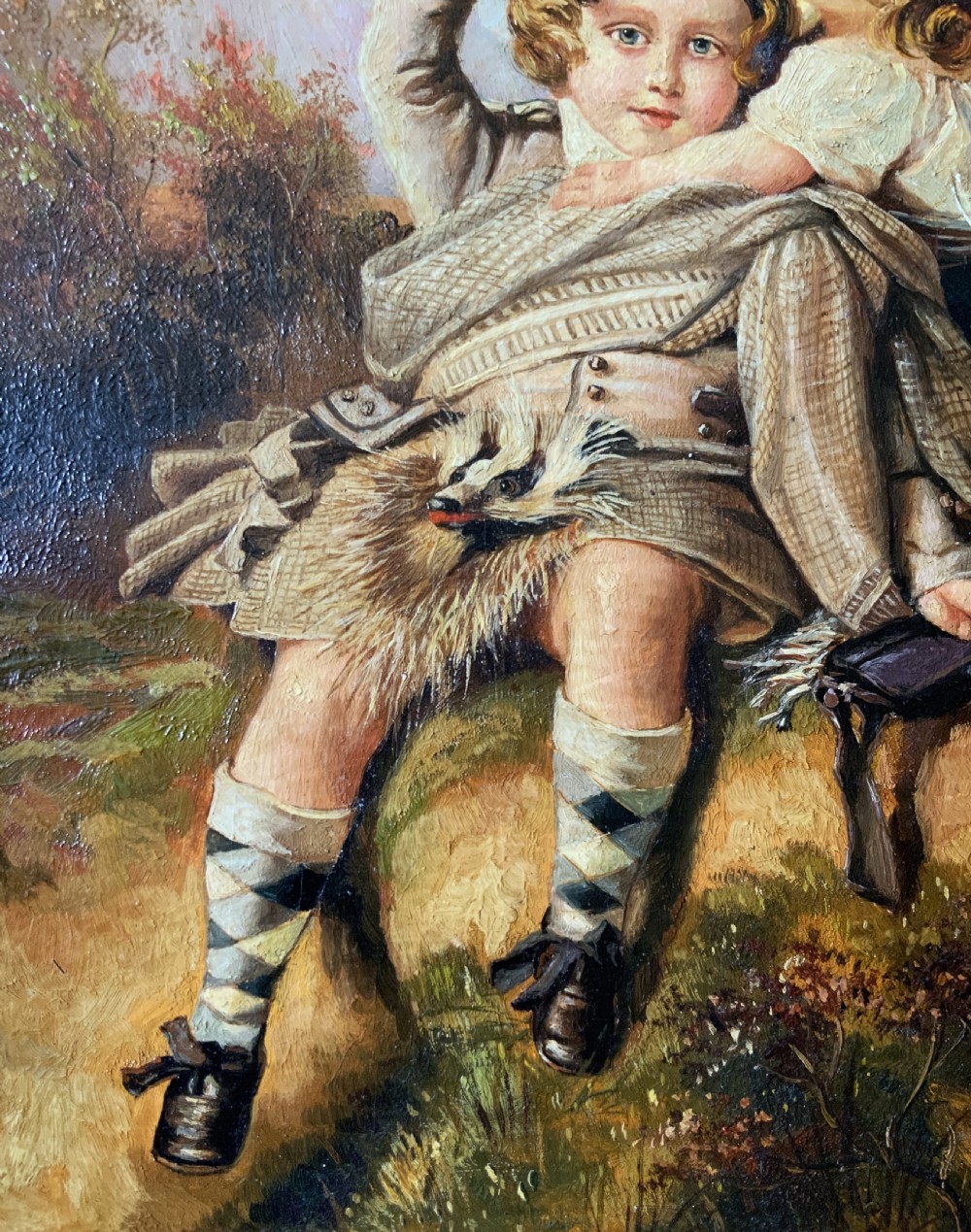 A 19th-century framed oil painting depicting two young children in traditional Scottish Highland dress set within a molded timber frame. View VI