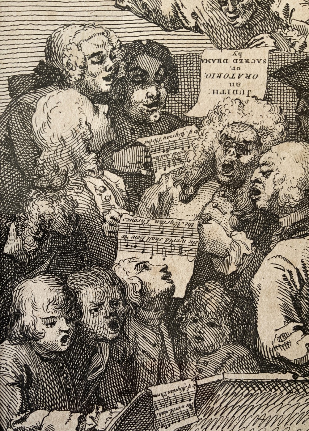 A framed monochrome etching depicting a group of 18th-century choir singers holding music scores, set within a cream mount and a black and gold moulding frame. View VII