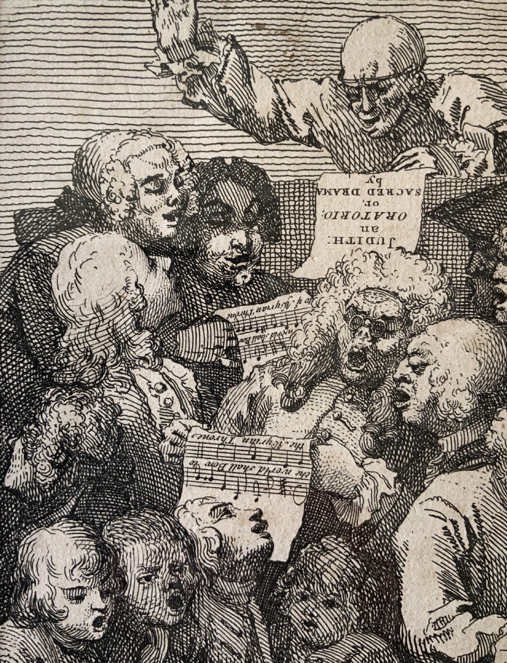 A framed monochrome etching depicting a group of 18th-century choir singers holding music scores, set within a cream mount and a black and gold moulding frame. View VIII