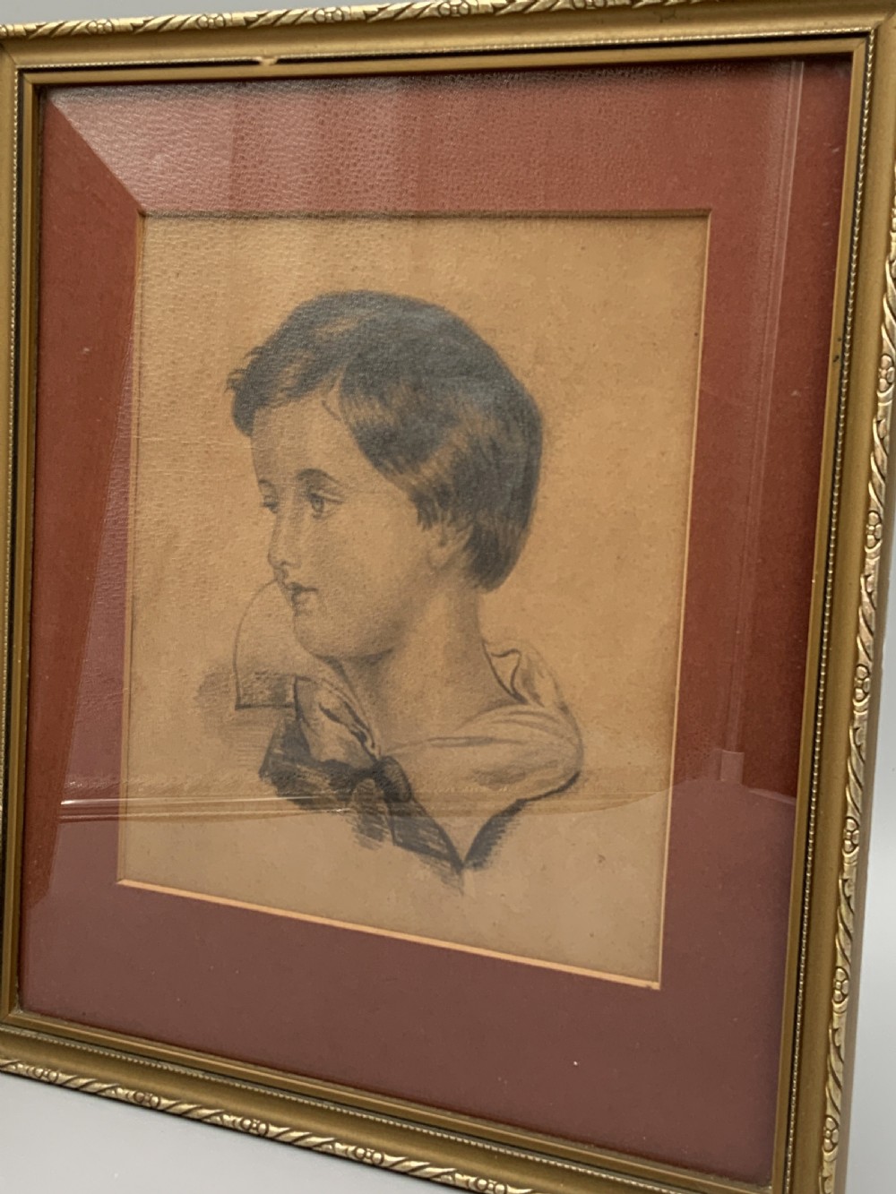Pair of 19th-century pencil portrait drawings depicting children in gilded frames with reddish-brown mounts. View II