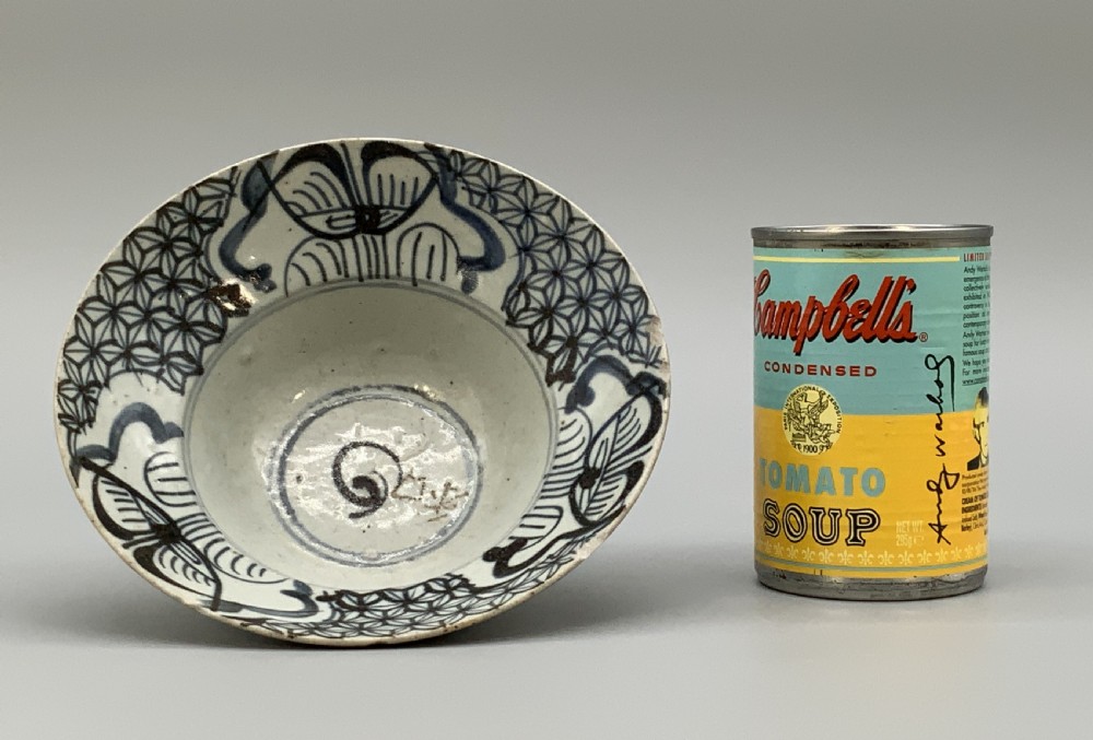 A 17th-century Chinese Swatow porcelain bowl featuring hand-painted underglaze blue geometric and floral motifs on an off-white glazed surface. View III
