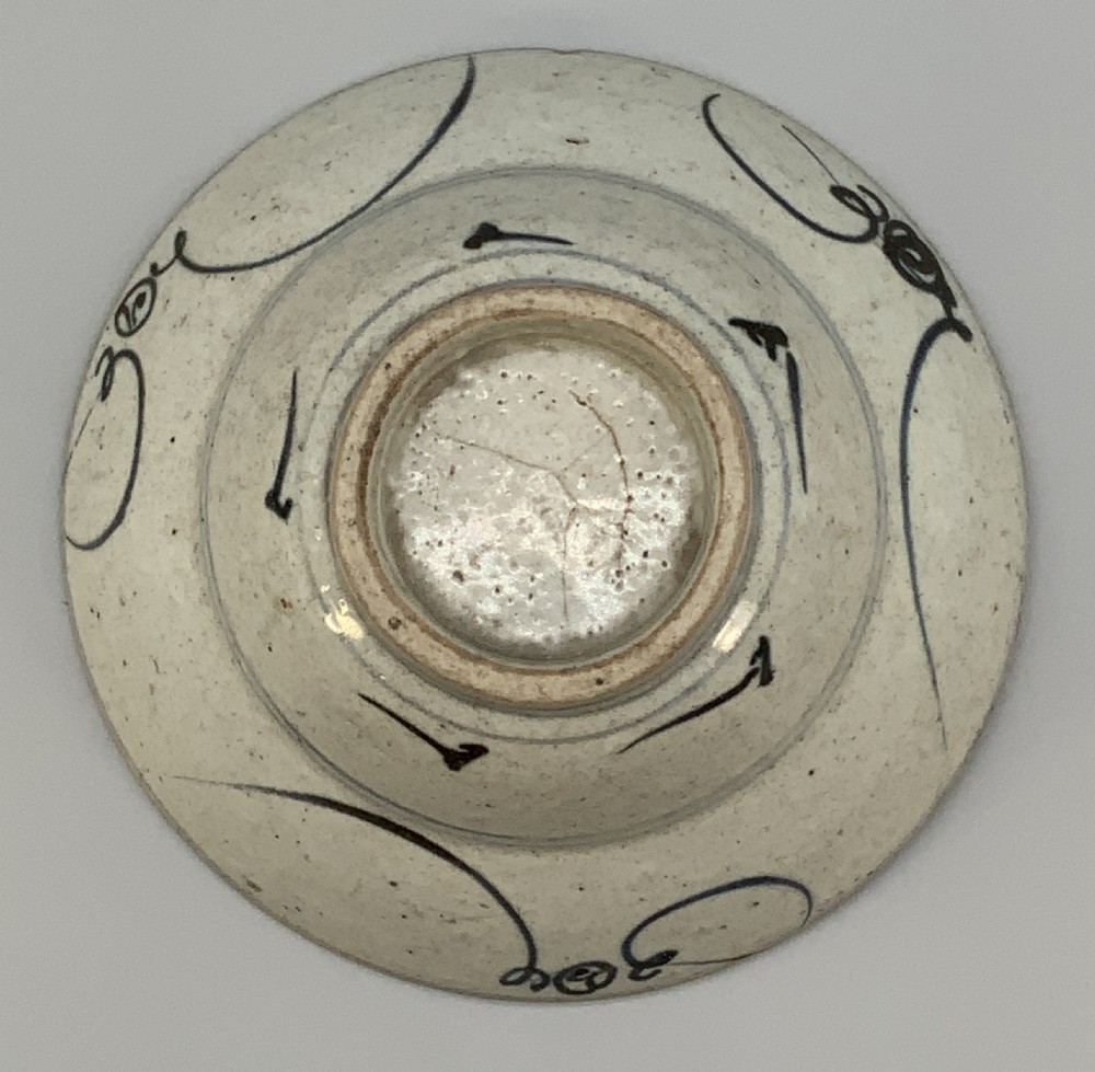 A 17th-century Chinese Swatow porcelain bowl featuring hand-painted underglaze blue geometric and floral motifs on an off-white glazed surface. View XII