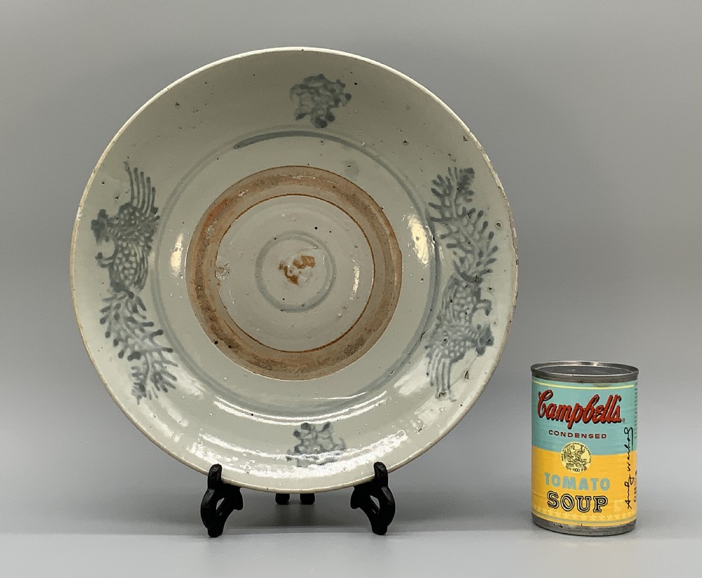 A large circular Ming Dynasty Swatow porcelain charger displaying hand-painted grey-blue phoenix motifs around an unglazed central ring. View III