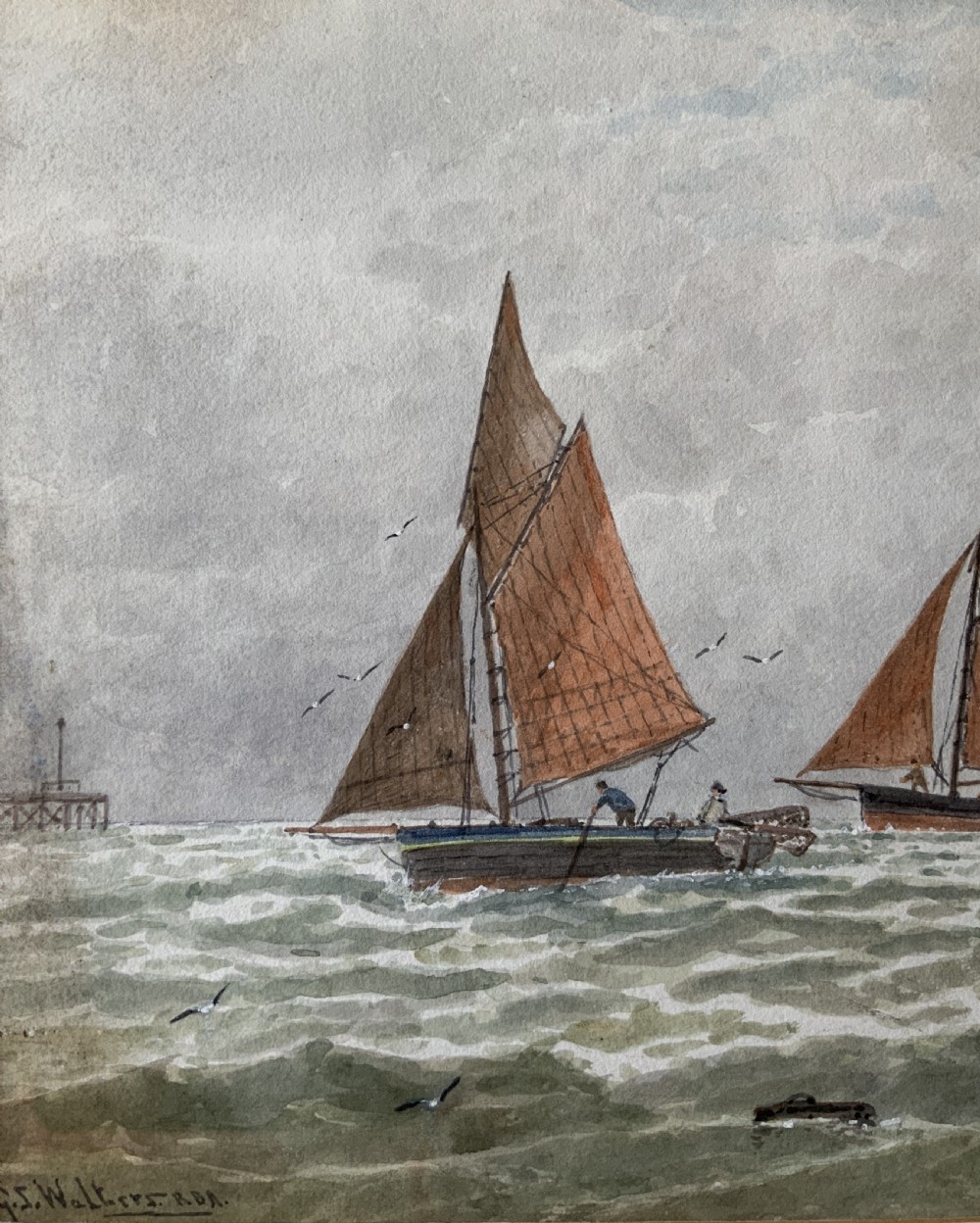 Framed Victorian watercolour painting featuring sailing barges with brown sails on choppy green waters under a cloudy sky. View VII