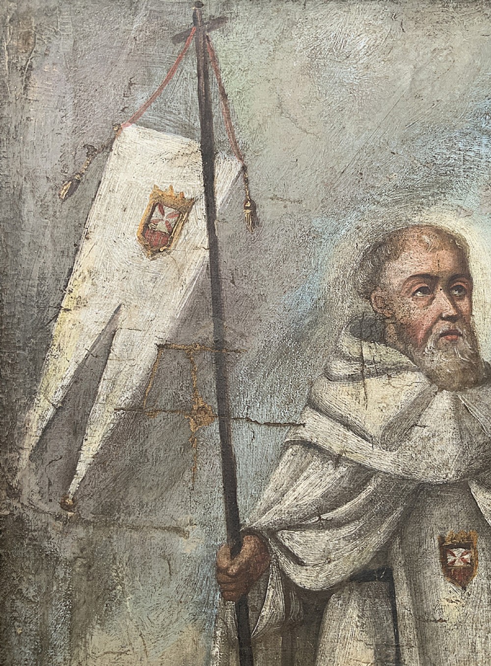 A 17th-century Spanish Baroque oil painting depicting a saint in a habit holding a banner alongside a kneeling figure, housed within an ornate carved giltwood lattice frame with mirrored glass inserts. View VII