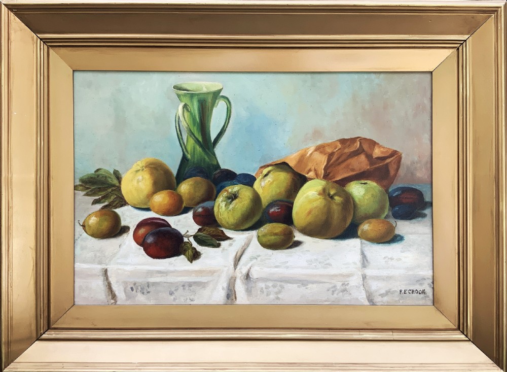 An Edwardian oil painting depicting a tabletop arrangement of apples, plums, and a green vase inside a broad gilt frame.