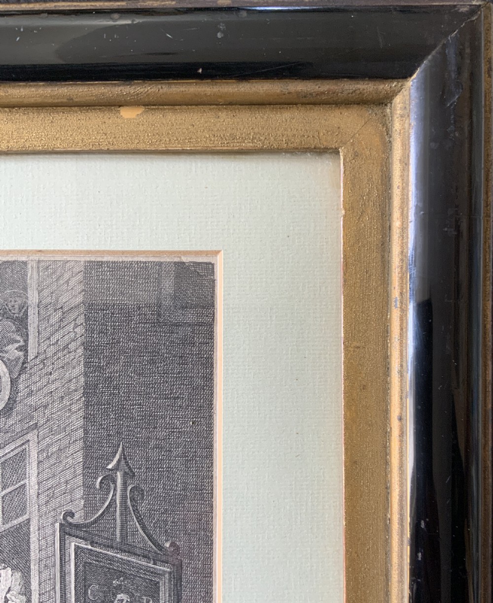 An 18th-century black and white satirical engraving depicting a crowded street scene with soldiers, housed in a black and gold frame with a cream mount. View XIV