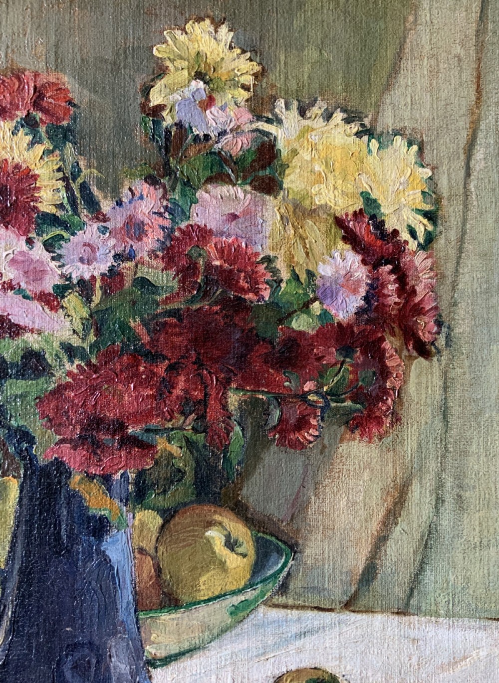 A framed 1931 impressionist oil painting depicting a vase of colourful flowers, a brass kettle, and fruit on a white draped table. View X
