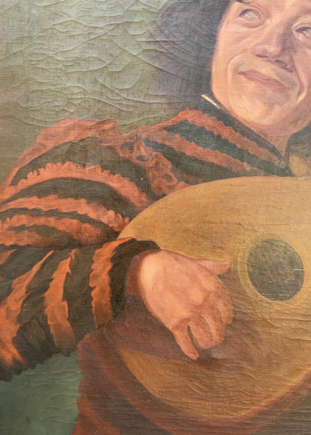An oil painting on canvas depicting a seated musician playing a lute in a red and black striped tunic against an olive green background, housed within a dark carved frame. View XI