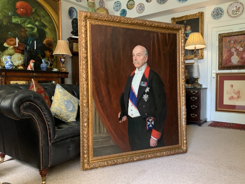 A pair of large 19th-century oil paintings depicting a gentleman in military uniform and a lady in formal dress, framed in heavy gilded mouldings. View II