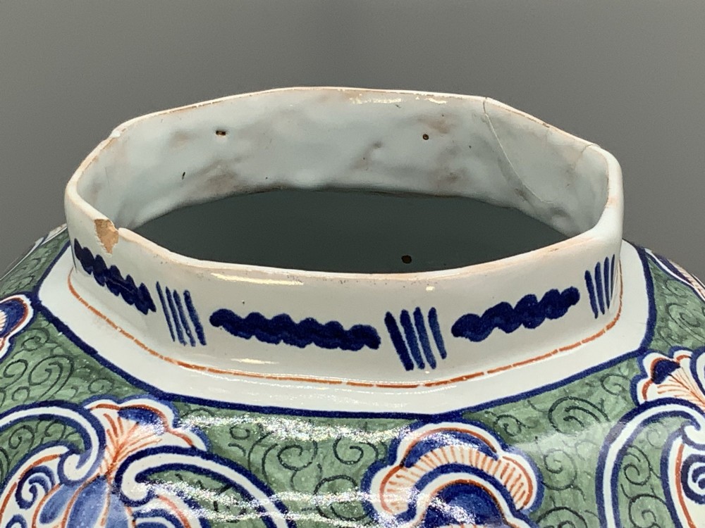 An octagonal tin-glazed ceramic baluster vase with a matching cover topped by a sculpted lion finial and decorated with multi-coloured floral panels. View XI