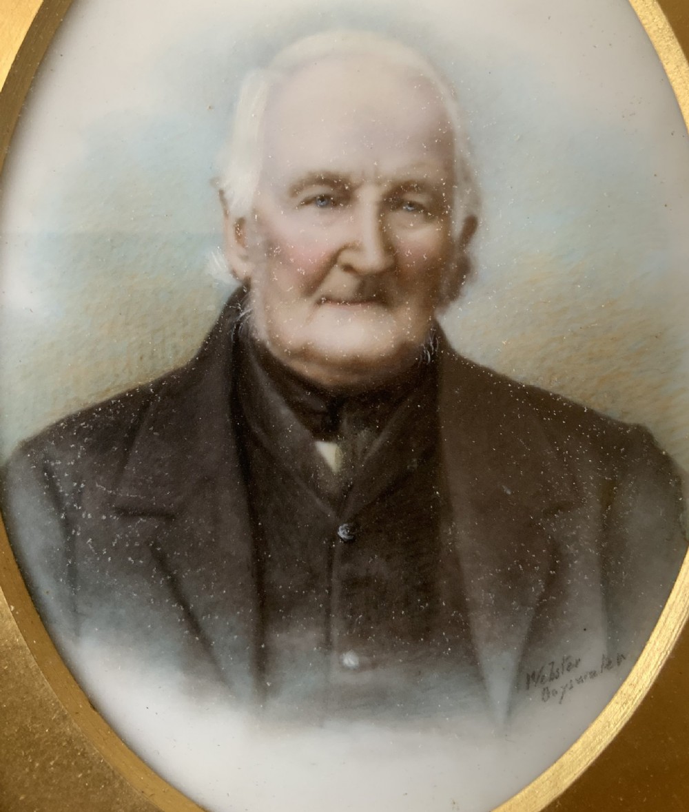 An oval Victorian miniature watercolour portrait of an elderly gentleman in a dark suit, set within a gilded frame. View VI