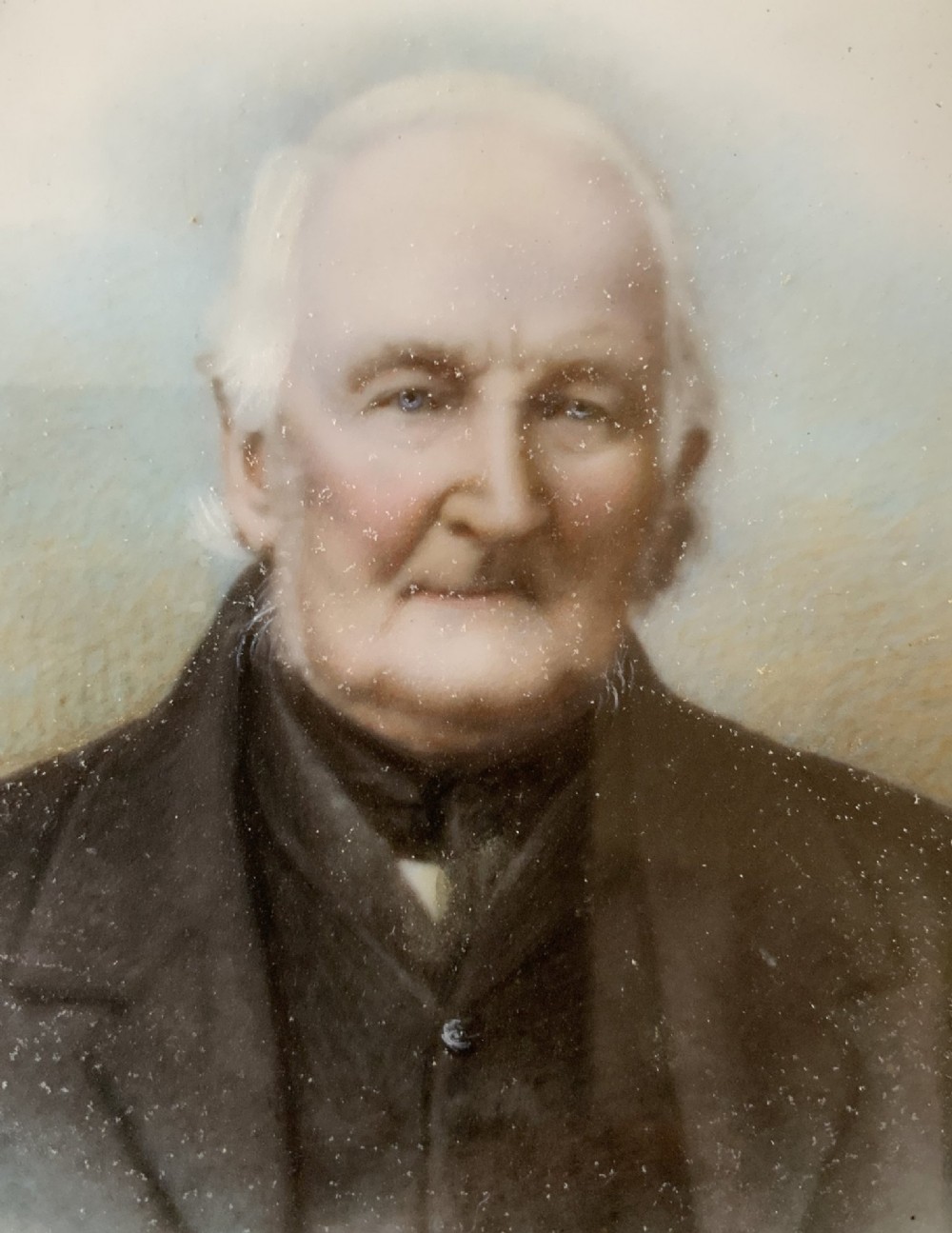 An oval Victorian miniature watercolour portrait of an elderly gentleman in a dark suit, set within a gilded frame. View VII