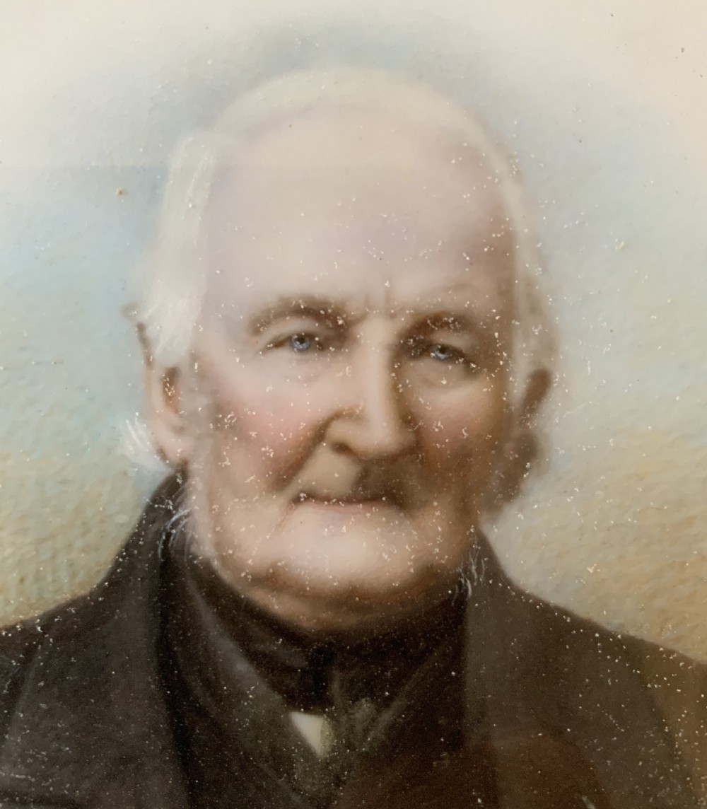 An oval Victorian miniature watercolour portrait of an elderly gentleman in a dark suit, set within a gilded frame. View IX