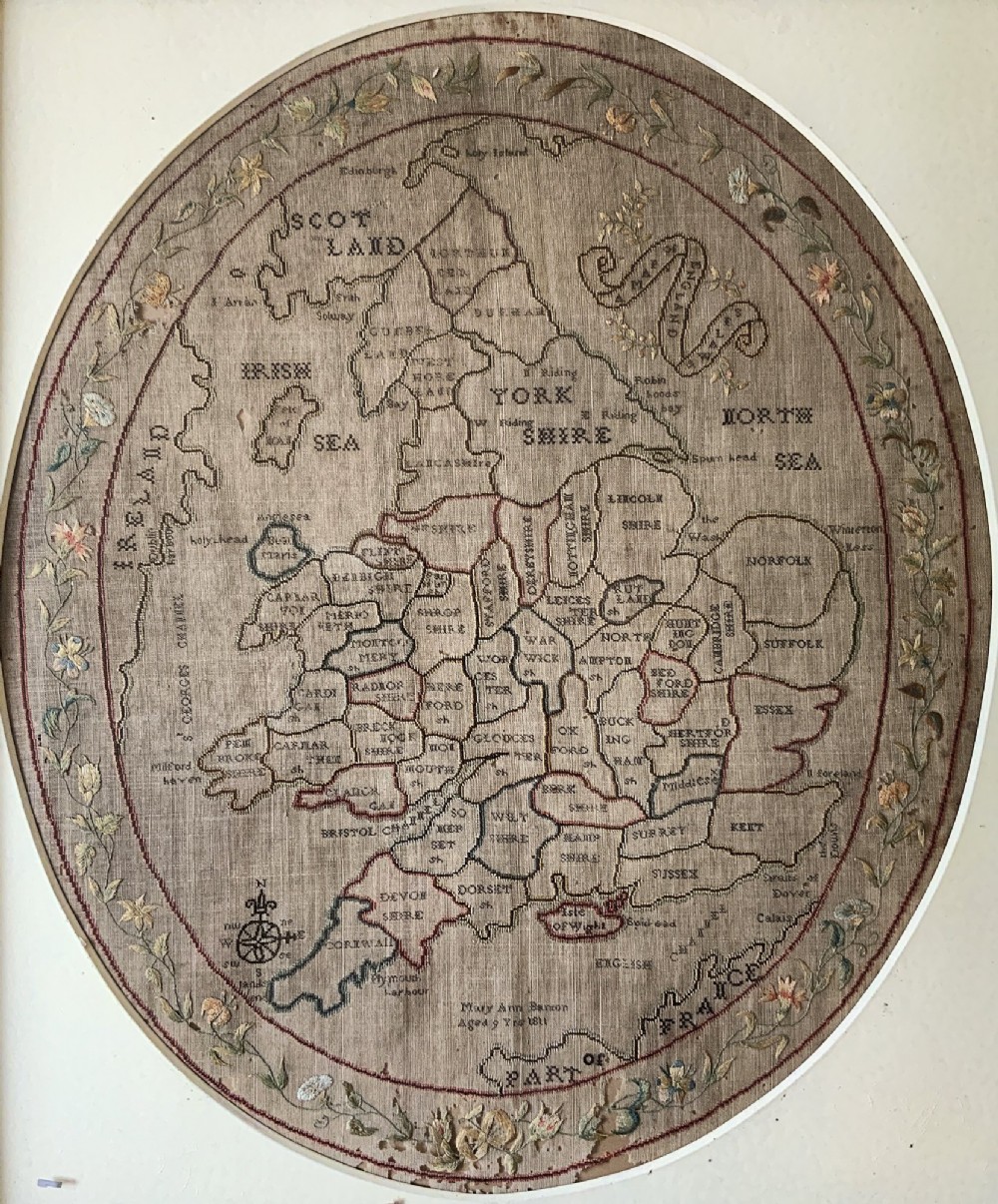 An oval Georgian embroidered needlepoint map of England and Wales with floral borders inside a gilt wooden frame. View III