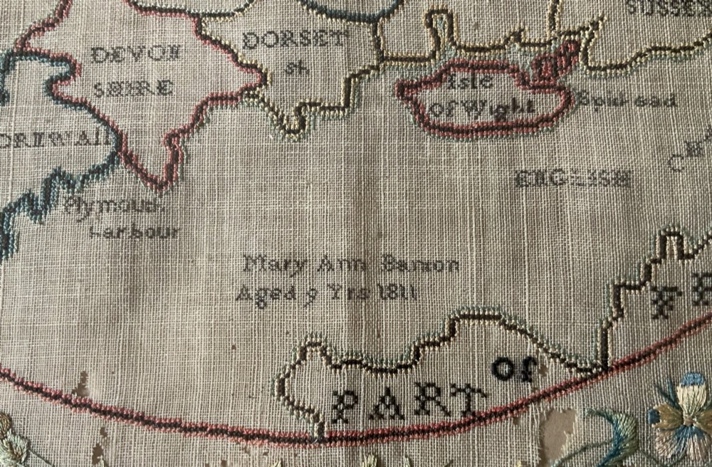 An oval Georgian embroidered needlepoint map of England and Wales with floral borders inside a gilt wooden frame. View IV