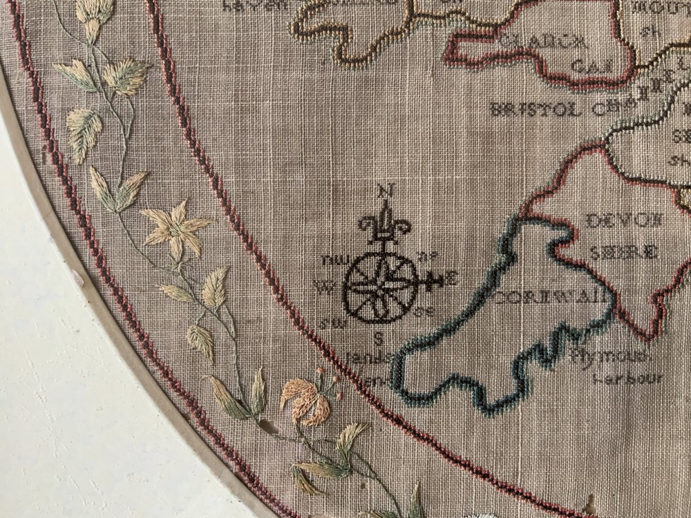 An oval Georgian embroidered needlepoint map of England and Wales with floral borders inside a gilt wooden frame. View VIII