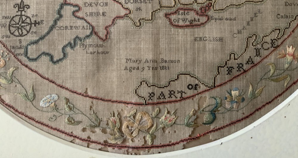 An oval Georgian embroidered needlepoint map of England and Wales with floral borders inside a gilt wooden frame. View XI