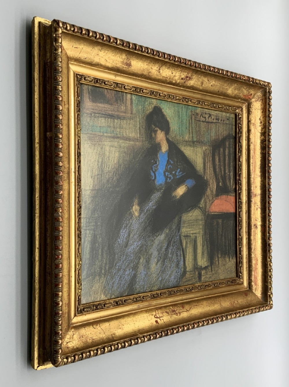 A framed limited-edition portrait print depicting a seated woman in a blue top and dark shawl, housed within a wide gilt decorative frame. View IV