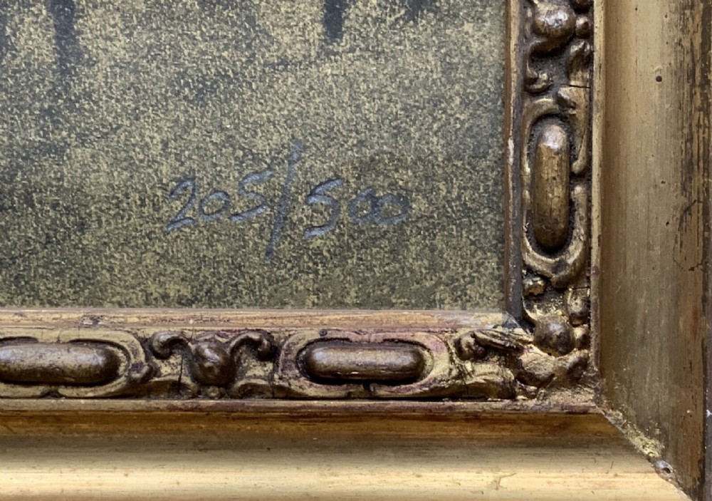 A framed limited-edition portrait print depicting a seated woman in a blue top and dark shawl, housed within a wide gilt decorative frame. View XII