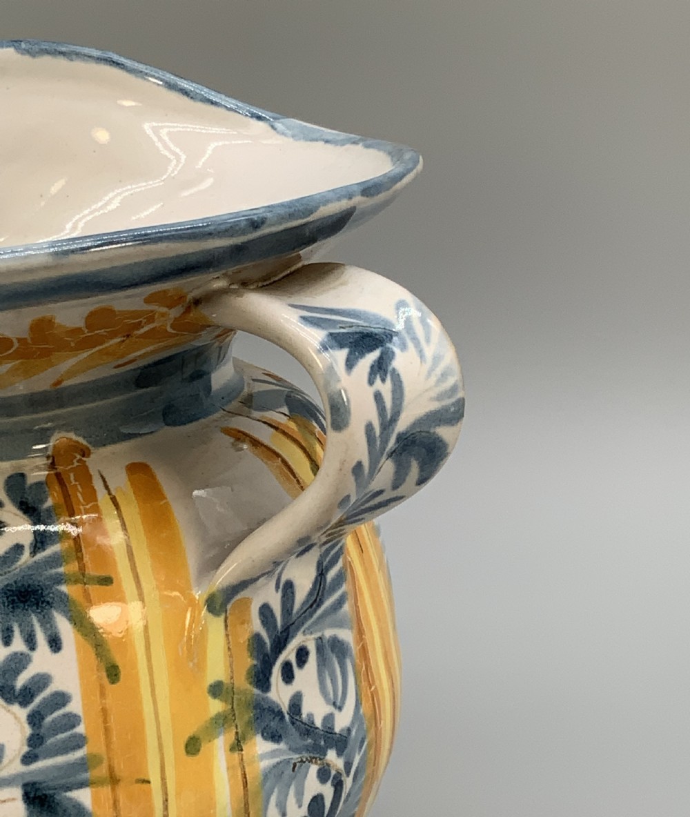 An antique Italian majolica earthenware pharmacy jug with hand-painted yellow, blue, and manganese script reading CARA BEVI IN PACE. View XIII