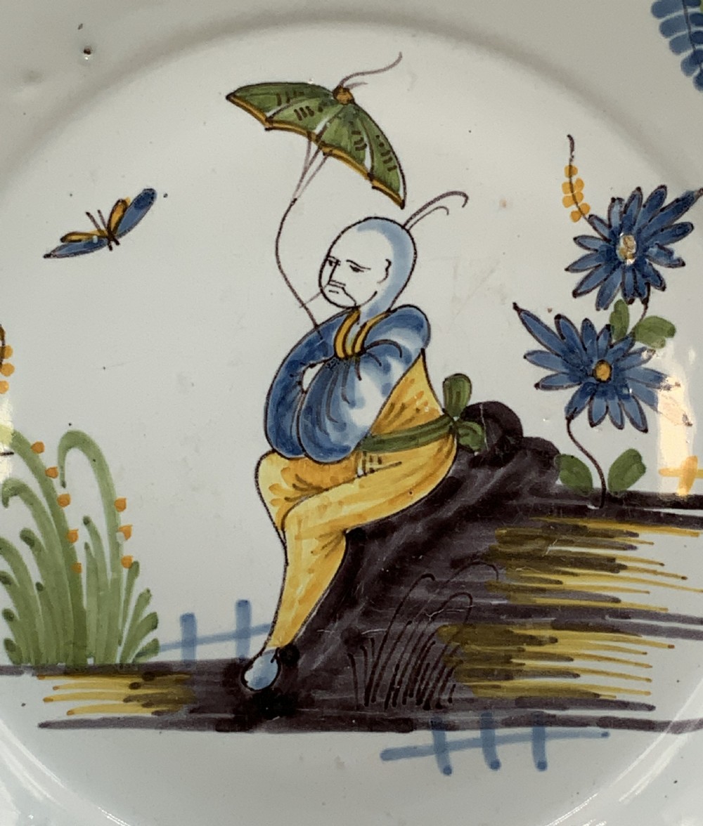 An 18th-century French tin-glazed earthenware charger with a lobed border featuring hand-painted Chinoiserie figures and floral motifs. View VIII