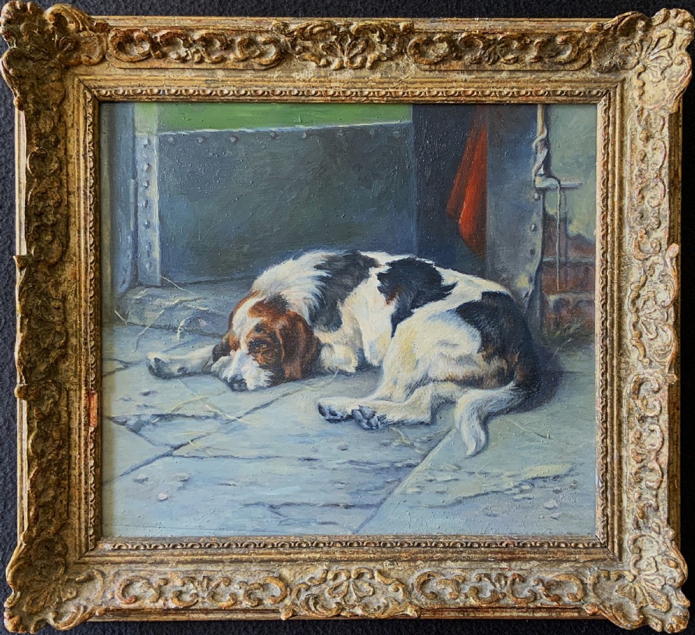 An oil painting depicting a resting tri-colour foxhound lying on a stone floor inside a doorway, housed in an ornate gilt frame.