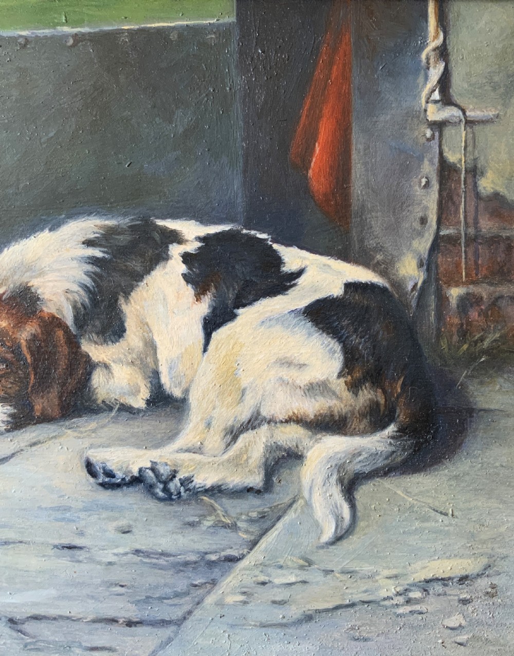 An oil painting depicting a resting tri-colour foxhound lying on a stone floor inside a doorway, housed in an ornate gilt frame. View V