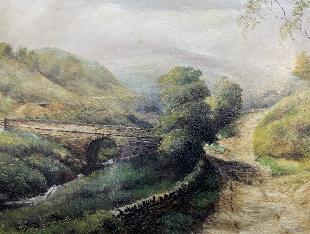 A 19th-century Victorian oil painting depicting a British rural landscape with a stone arch bridge, framed in an ornate gilded wooden frame. View IV