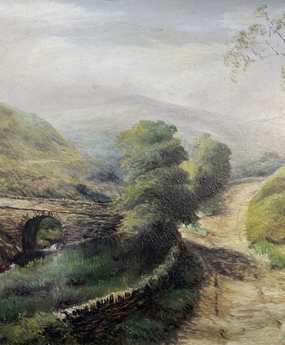 A 19th-century Victorian oil painting depicting a British rural landscape with a stone arch bridge, framed in an ornate gilded wooden frame. View VI