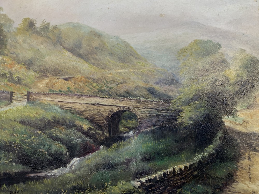 A 19th-century Victorian oil painting depicting a British rural landscape with a stone arch bridge, framed in an ornate gilded wooden frame. View VIII