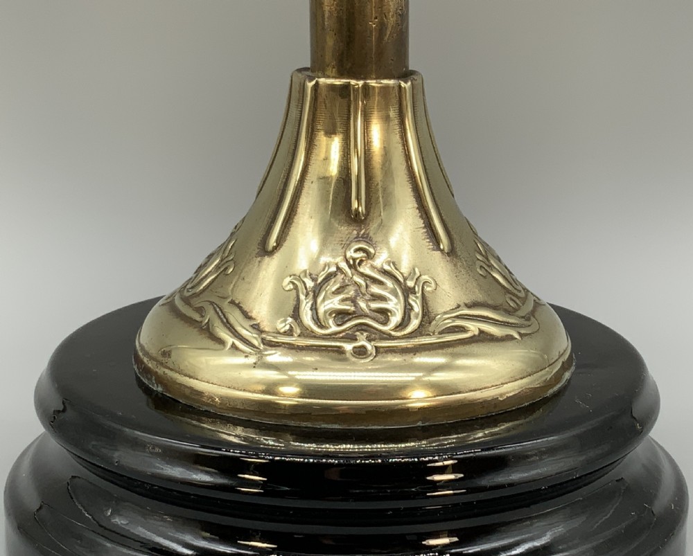 An Art Nouveau table oil lamp featuring a black ceramic base, cast brass stem, clear glass reservoir, double wick burner, clear chimney, and ruffled glass shade. View XI