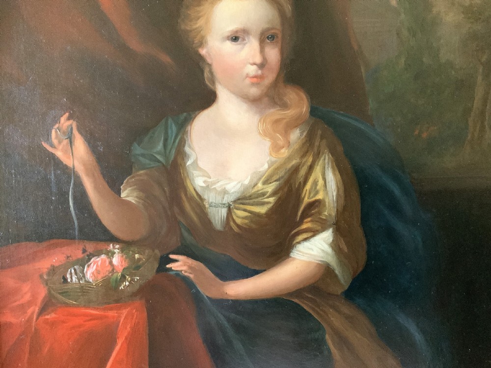 An antique oil painting depicting a seated woman beside a basket of flowers on a draped table, set within a gilded wooden frame. View VI