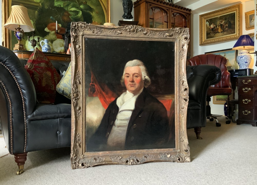 An antique oil painting on canvas depicting a gentleman in Georgian attire within an ornate gilt frame. View IV