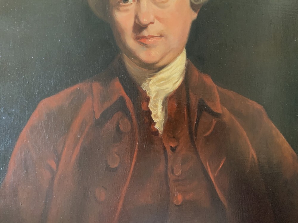 An oil portrait painting depicting an 18th-century gentleman in a burgundy coat and white cravat, set inside an ornate giltwood frame. View VI