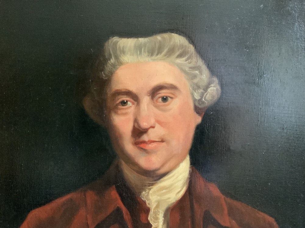 An oil portrait painting depicting an 18th-century gentleman in a burgundy coat and white cravat, set inside an ornate giltwood frame. View VII