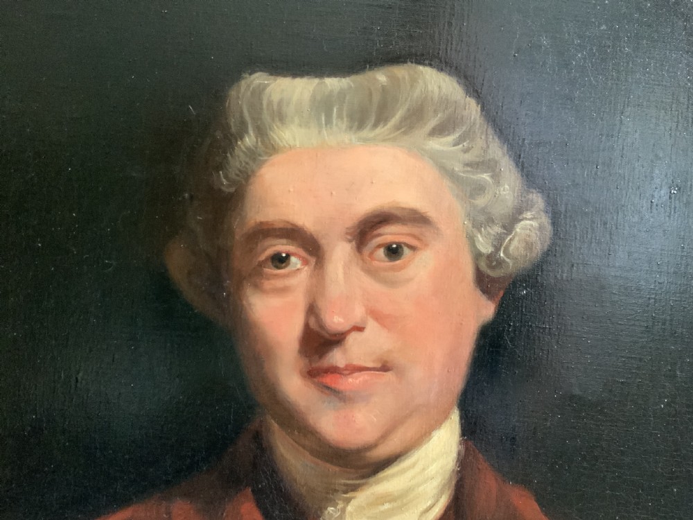 An oil portrait painting depicting an 18th-century gentleman in a burgundy coat and white cravat, set inside an ornate giltwood frame. View VIII