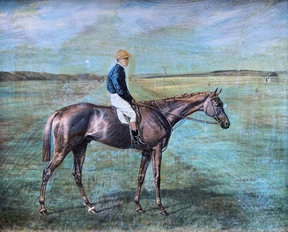 A framed miniature print depicting a jockey in blue silks seated on a dark racehorse in a countryside landscape, enclosed in a moulded timber frame with a gold inner slip. View VII