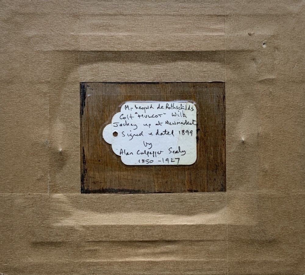 A framed miniature print depicting a jockey in blue silks seated on a dark racehorse in a countryside landscape, enclosed in a moulded timber frame with a gold inner slip. View IX