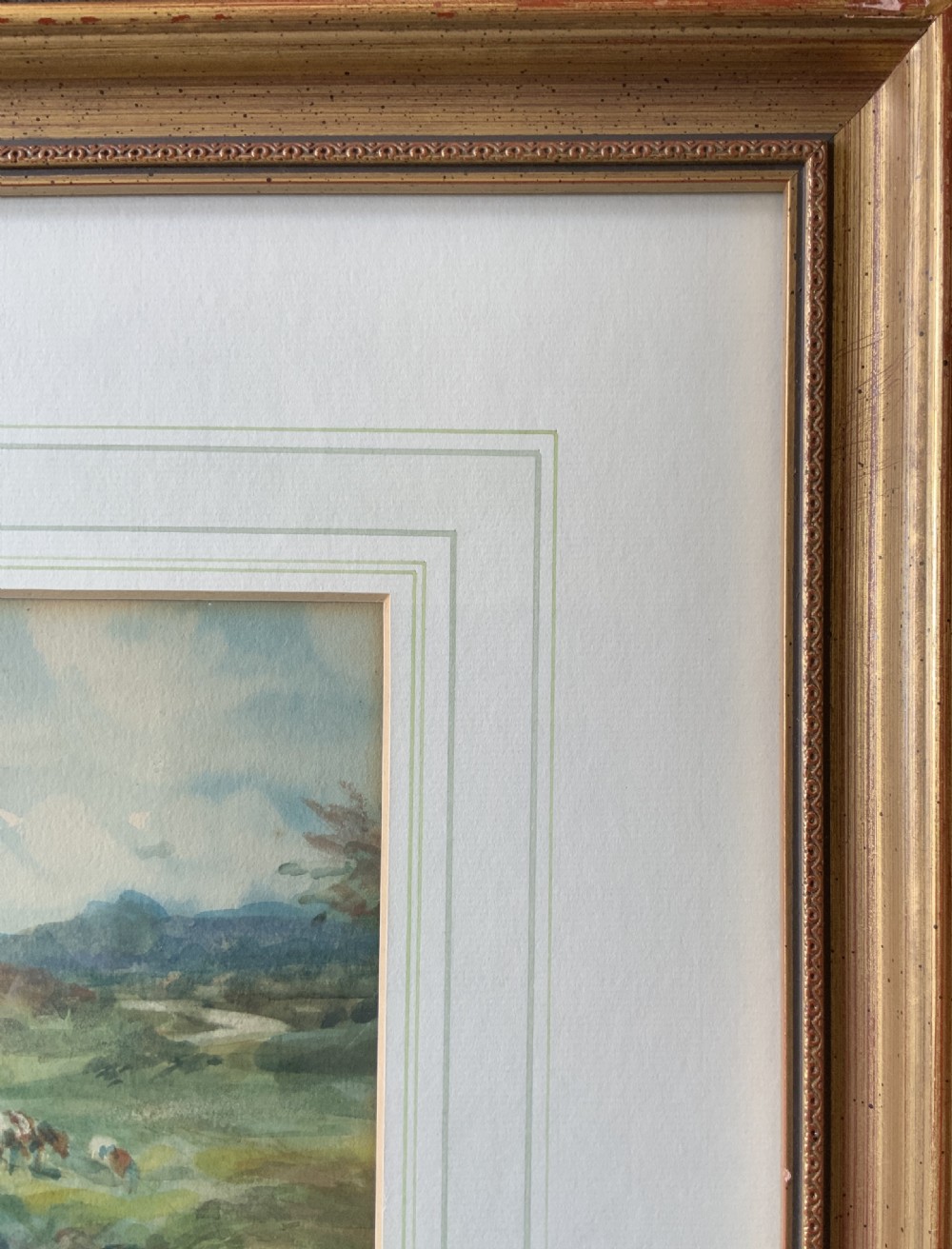 A framed antique watercolour painting depicting cattle grazing in a rural landscape, set within a layered mount and a moulded gilt frame. View IX