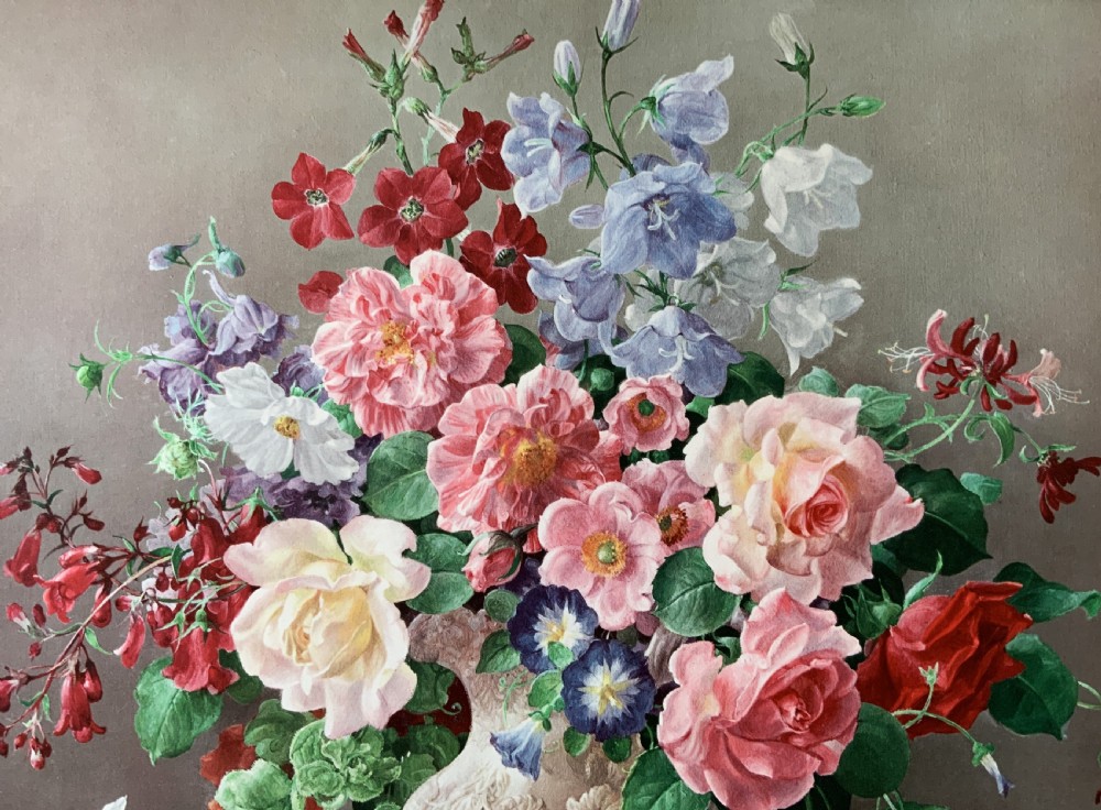 A framed oleograph print depicting a bouquet of pink, red, and blue garden flowers in an ornate ceramic urn on a stone ledge, enclosed within a decorative gilded frame. View V