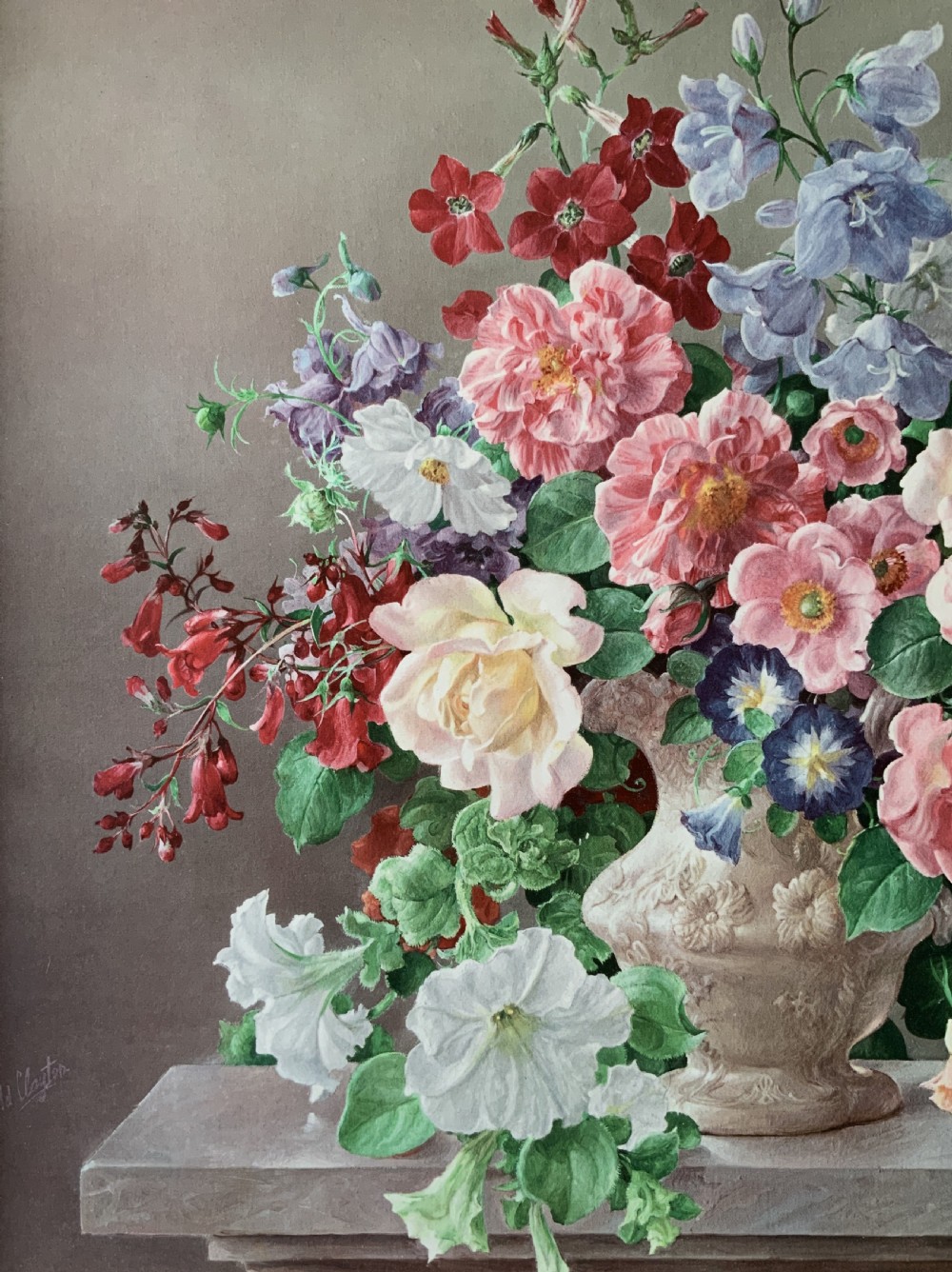 A framed oleograph print depicting a bouquet of pink, red, and blue garden flowers in an ornate ceramic urn on a stone ledge, enclosed within a decorative gilded frame. View VI