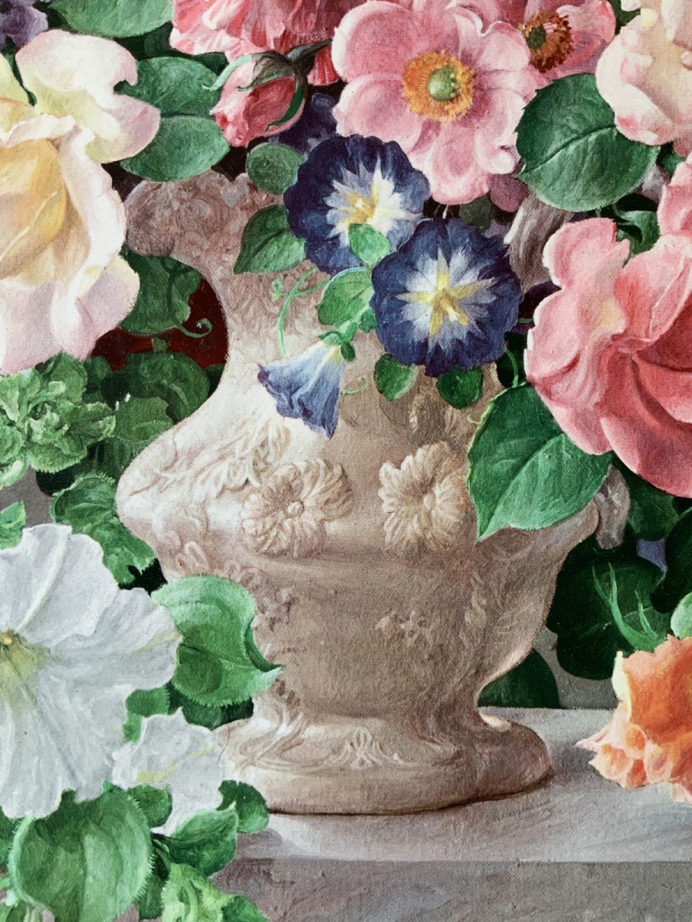 A framed oleograph print depicting a bouquet of pink, red, and blue garden flowers in an ornate ceramic urn on a stone ledge, enclosed within a decorative gilded frame. View IX