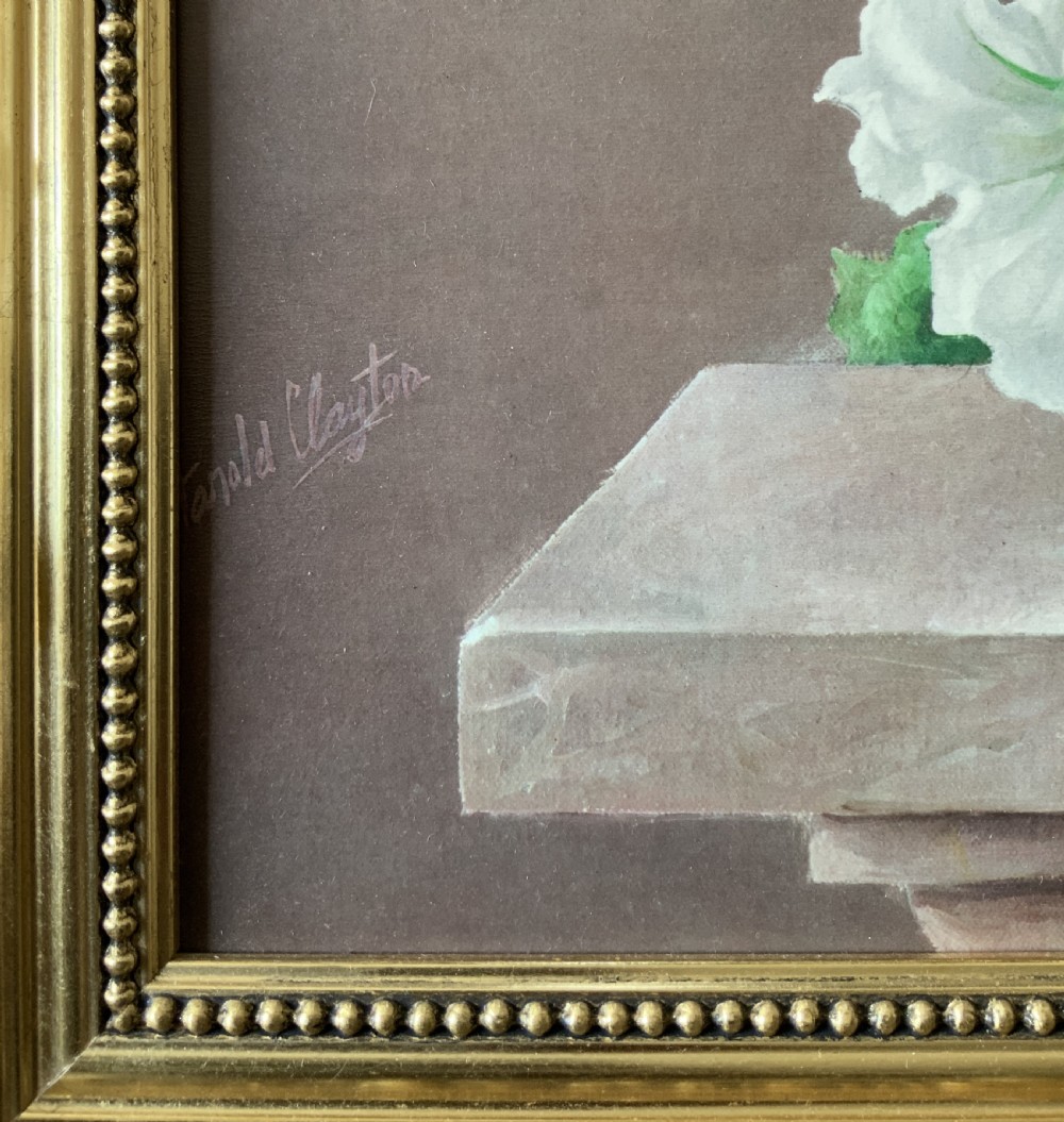A framed oleograph print depicting a bouquet of pink, red, and blue garden flowers in an ornate ceramic urn on a stone ledge, enclosed within a decorative gilded frame. View X